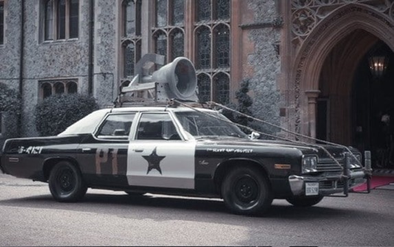 The Bluesmobile parked outside a church for a special event