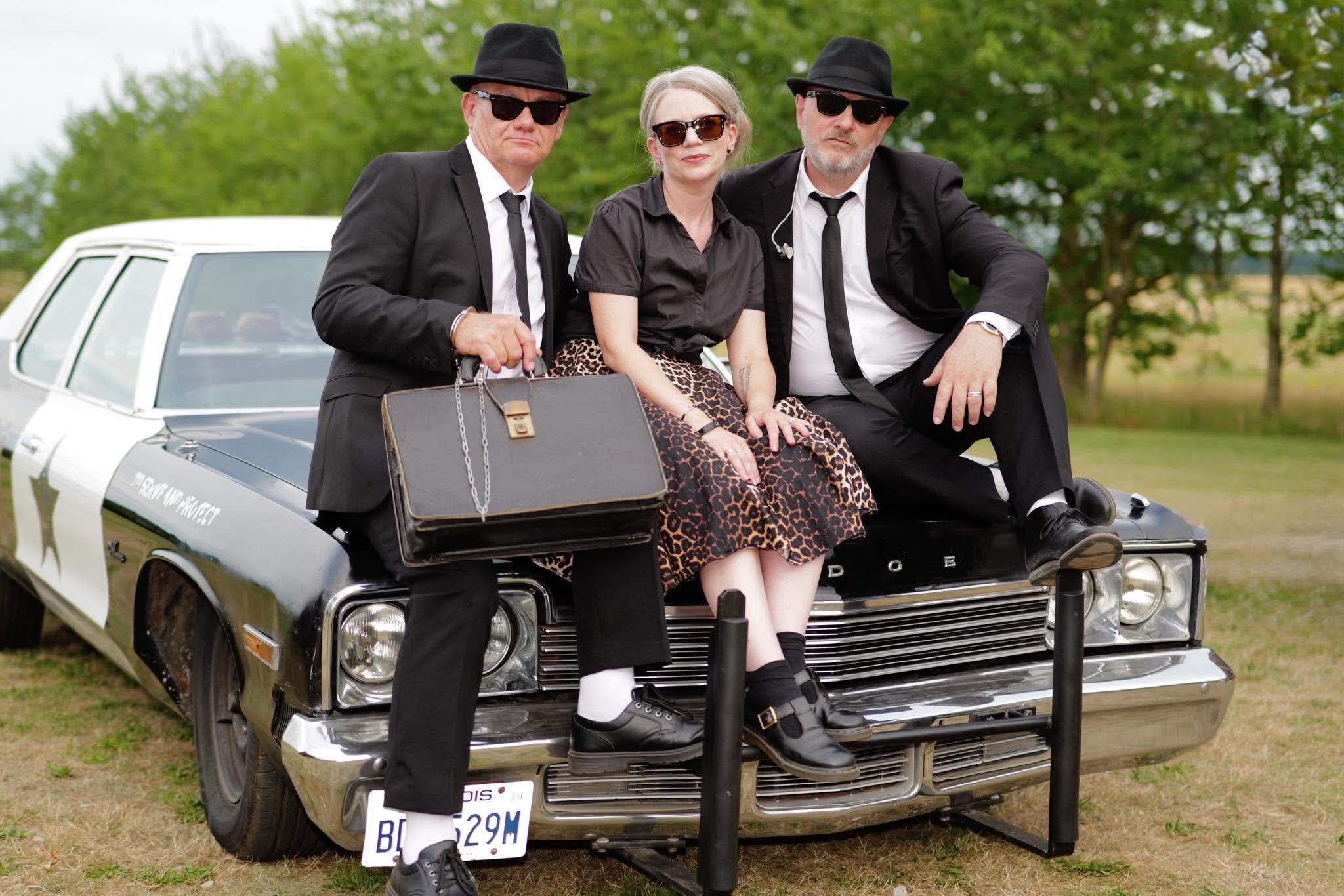 Three members of The All New Blues and Soul Revue with the Bluesmobile