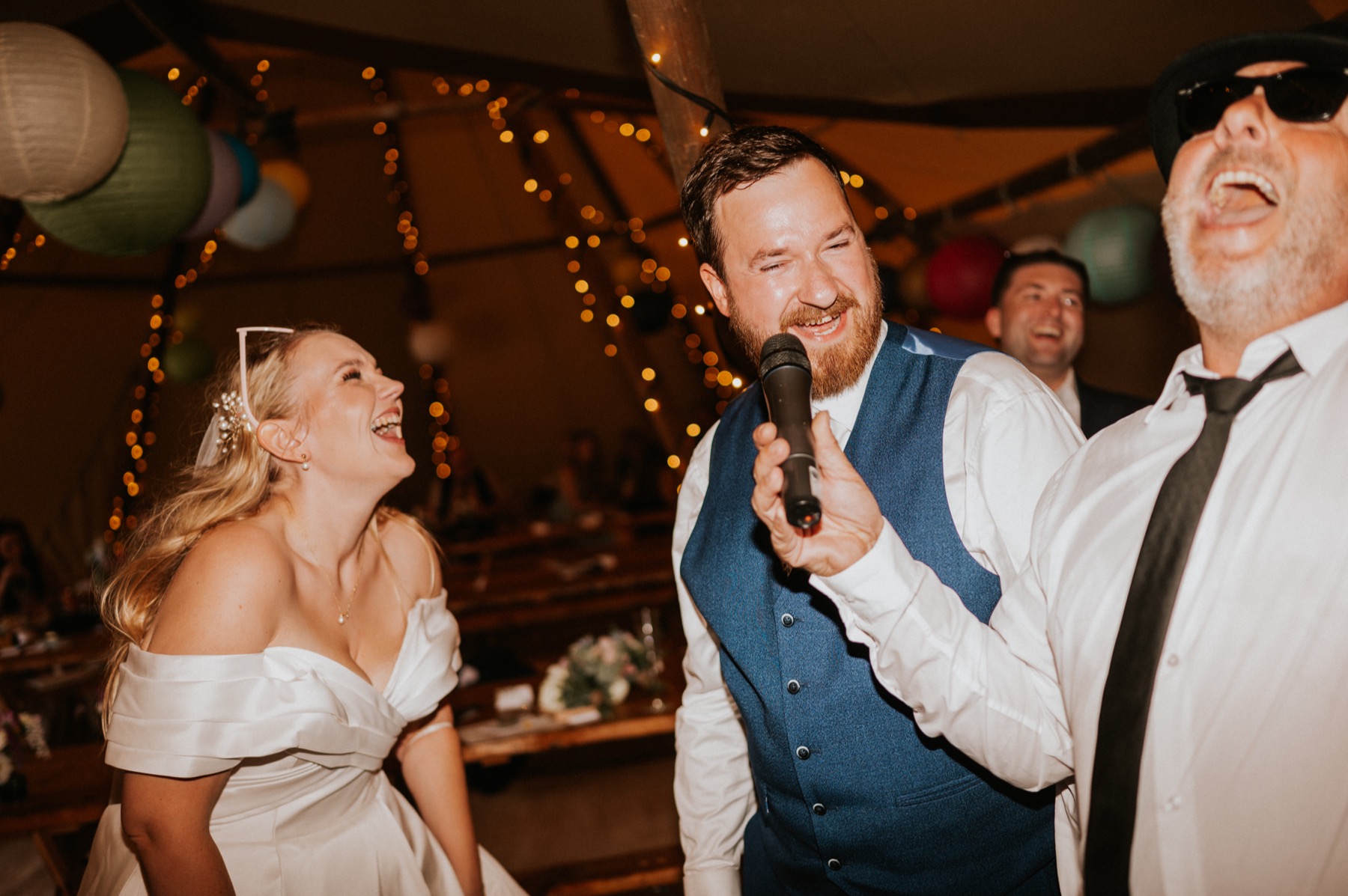 A bride and groom laughing during an interactive wedding performance